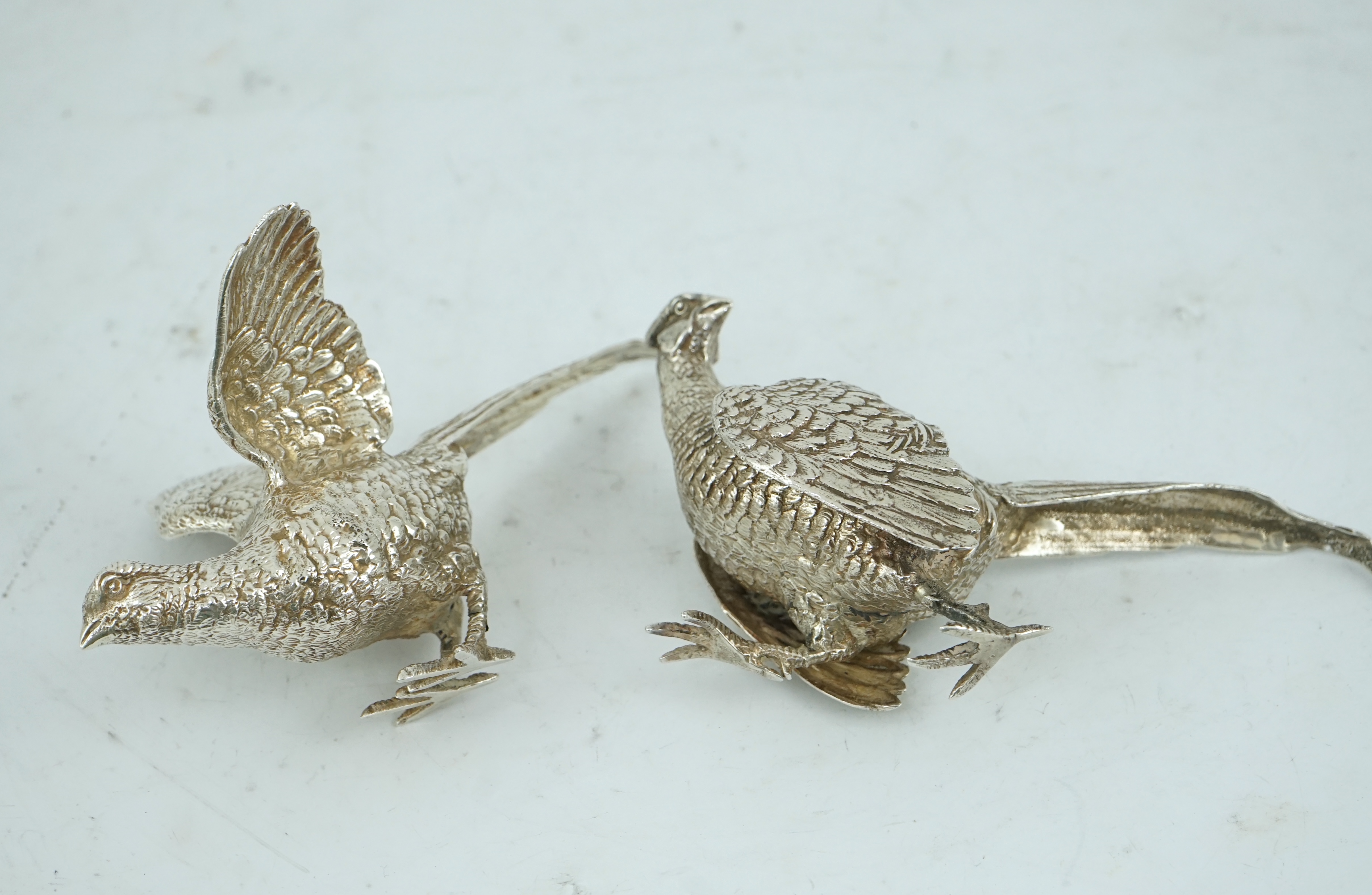 A pair of Elizabeth II silver free-standing model pheasants, by Edward Barnard & Sons Ltd